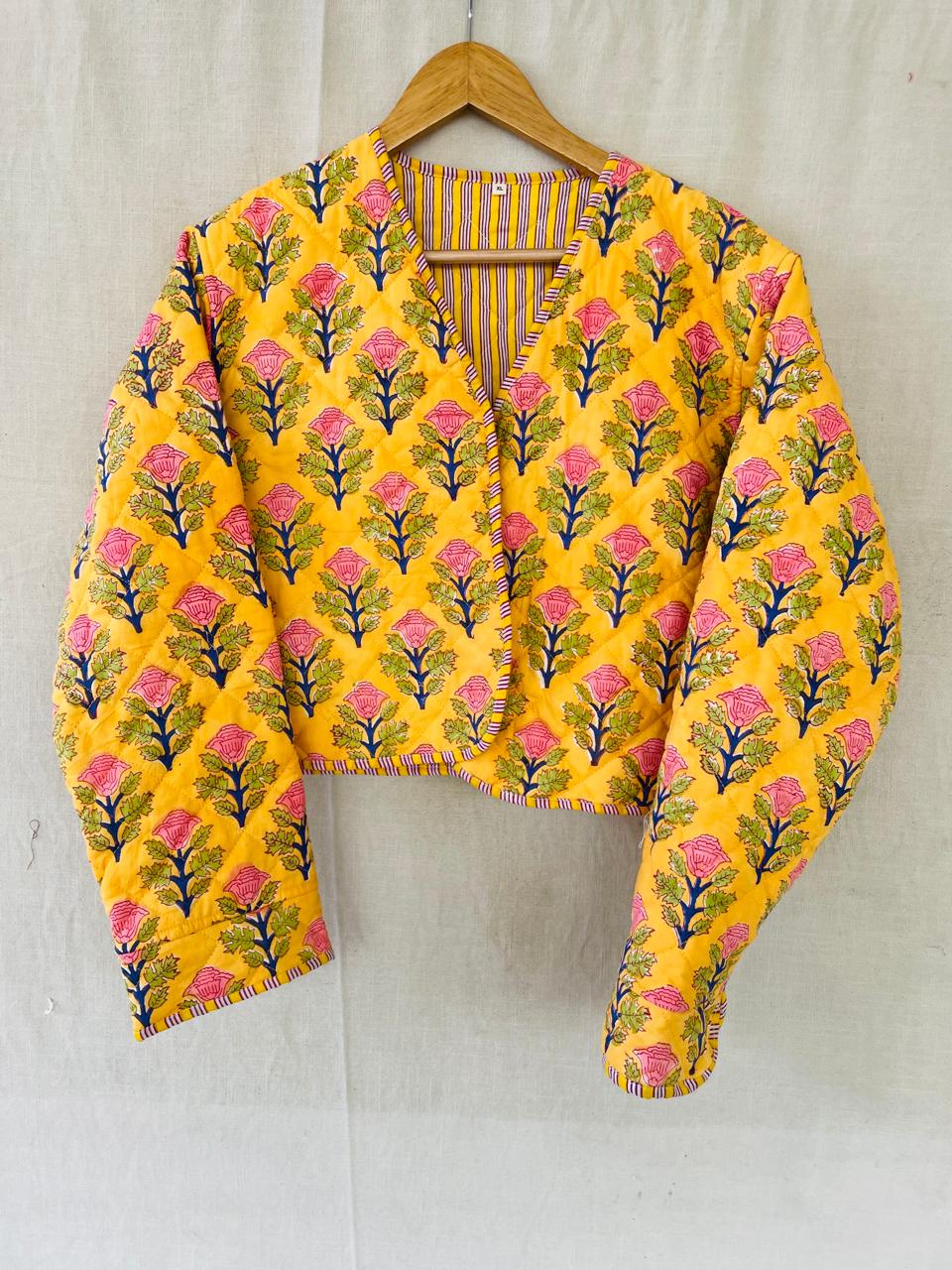 Morning: a cropped yellow quilted jacket printed with pink flowers, with striped lining and edging